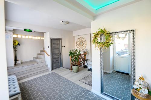 a hallway of a home with a door and stairs at Villa Royal in Craiova