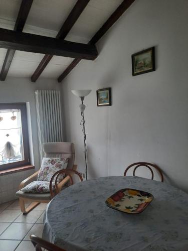 a dining room with a table and a chair at Flat in Chiesina Uzzanese in Chiesina Uzzanese