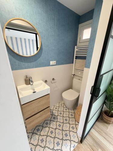 a bathroom with a sink and a mirror at Lively Sopela House by Kima Gestíon in Sopelana