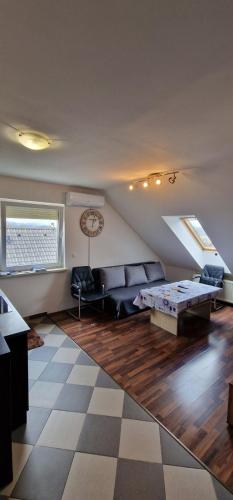 a living room with a couch and a table at Apartman MURKO S-3 in Ig
