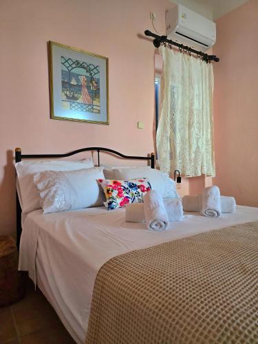 a bedroom with a bed with white sheets and a window at 1939 in Kini