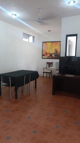 a room with a ping pong table and a television at Casa Albino in Izamal