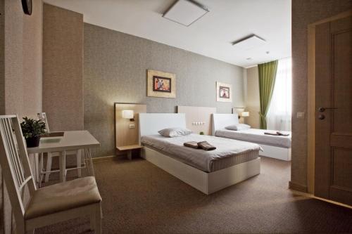 A bed or beds in a room at Orda Hotel