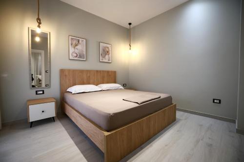 a bedroom with a large bed with a wooden frame at Julis Villa in Draç