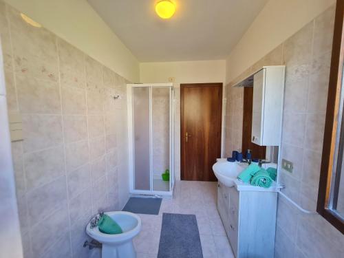 a bathroom with a sink and a toilet and a tub at Villa La Pief - Gardasee by Garda Domus Mea in Tremosine Sul Garda