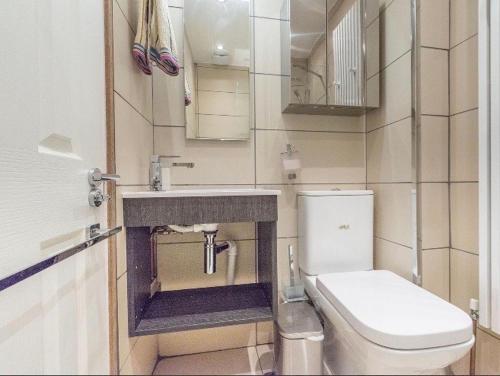 a small bathroom with a toilet and a sink at Soofi House in Sheffield
