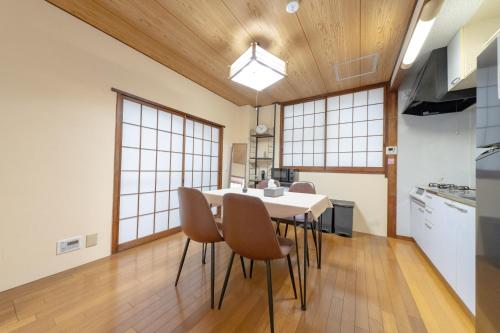 a kitchen and dining room with a table and chairs at ON SALE 13 minutes by Haneda Airport train, 15 minutes walking distance by station, fully equipped with a record player, maximum 5 people in Tokyo