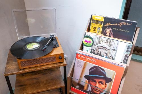 a record player and a vinyl album on a table at ON SALE 13 minutes by Haneda Airport train, 15 minutes walking distance by station, fully equipped with a record player, maximum 5 people in Tokyo