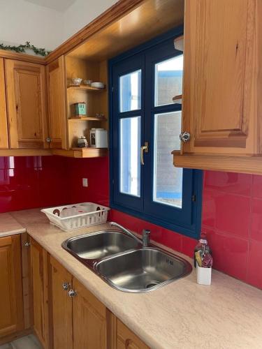 a kitchen with a sink and a window at Dejableu - Island Living Paros in Sarakíniko