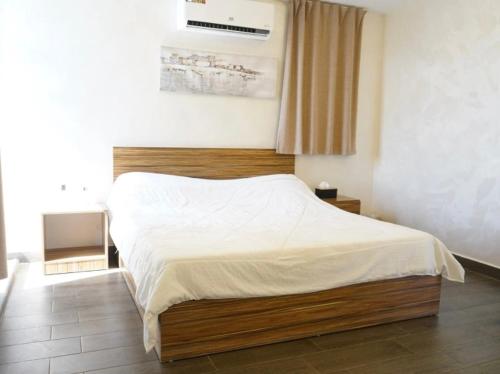 a bedroom with a large bed with white sheets at Atlantis The Palm Villa 2 in Al Rama
