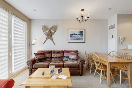 a living room with a couch and a table at Long Trail House 459 in Stratton