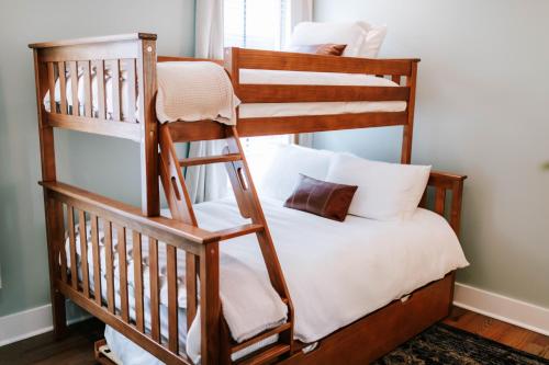 a bedroom with two bunk beds and a ladder at Azalea & Blackberry Cabins in Jasper