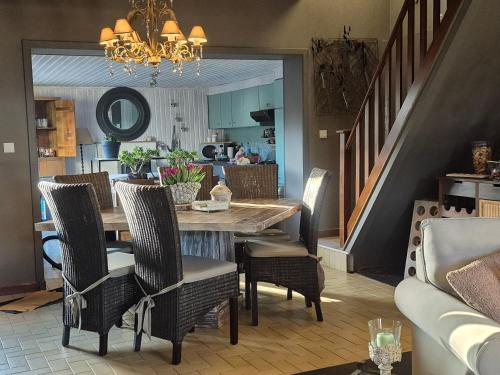 a dining room with a table and chairs at La Constance in Chièvres