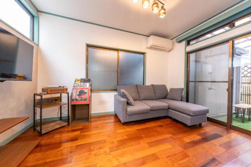 a living room with a couch and a tv at ON SALE 13 minutes by Haneda Airport train, 15 minutes walking distance by station, fully equipped with a record player, maximum 5 people in Tokyo
