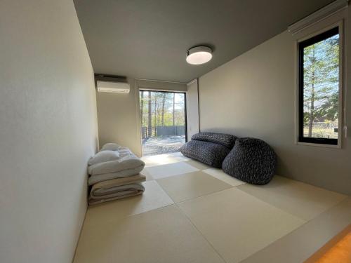 a living room with a couch and a window at Fuji Yamanakako Villa in Yamanakako