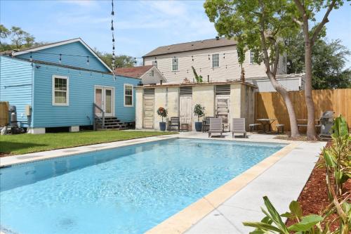 a swimming pool in front of a house at Sunny 5Bed w Parking and direct Streetcar access in New Orleans