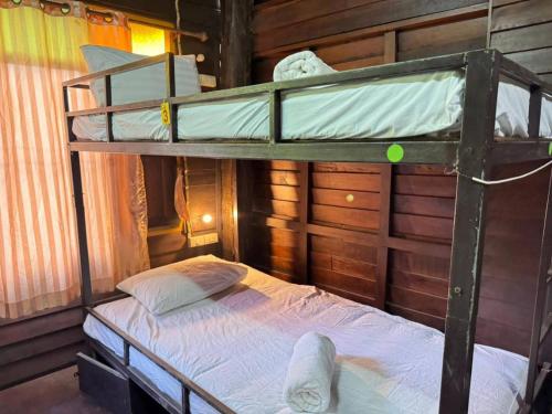 a bedroom with two bunk beds in a cabin at Belvilla Baan Elephant Home in Chiang Mai