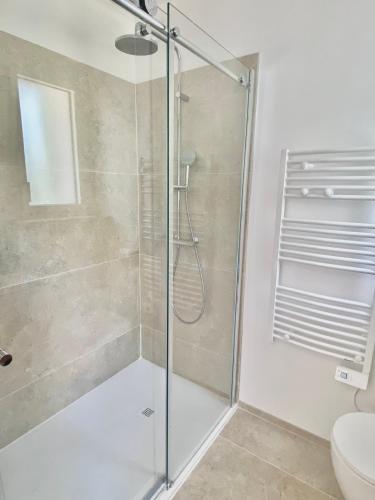 a shower with a glass door in a bathroom at L'échappée in Viols-le-Fort