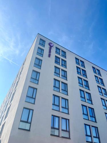 a tall white building with a purple dragon on it at Premier Inn München City West in Munich