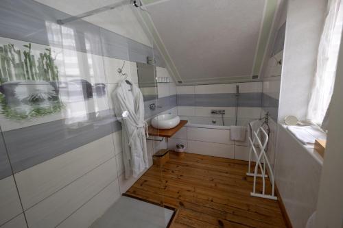 a bathroom with a sink and a bath tub at Villa l'Orante in Lourdes