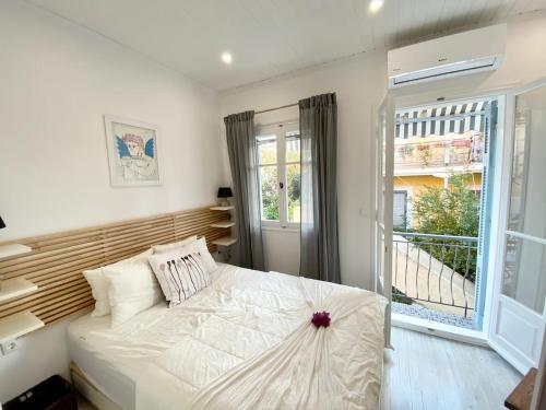 a bedroom with a bed and a large window at Apollo House in Lefkada