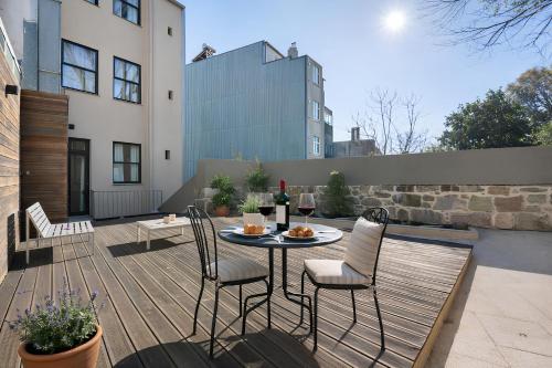 a patio with a table and chairs on a deck at FindMe InPorto Bonfim in Porto