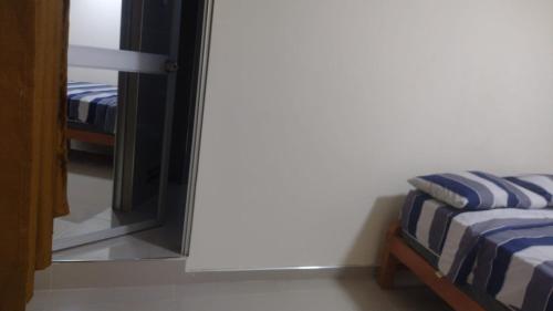 a bedroom with a mirror and a bed in a room at Habitaciones Chincha in Sunampe