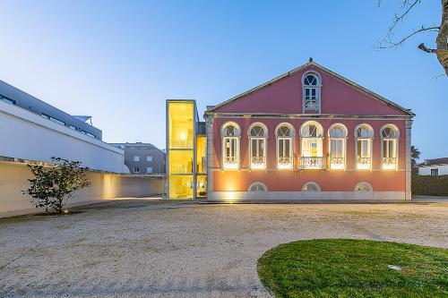 a large building with lights on the side of it at HI Vila do Conde - Pousada de Juventude in Vila do Conde