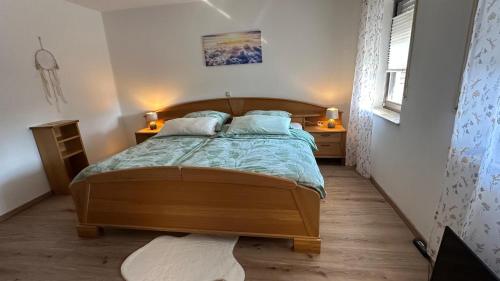 a bedroom with a wooden bed with two night stands at Ferienwohnung Wirtz in Olzheim
