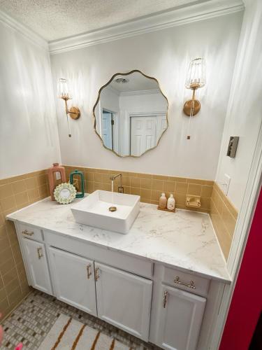 a bathroom with a white sink and a mirror at The Joyful Escape in Crewe