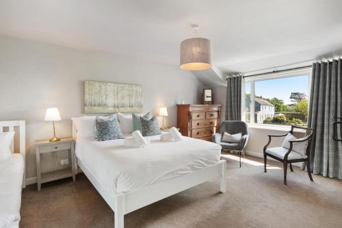 a bedroom with a white bed and a window at 2 Bed in St. Brides oc-s30491 in Saint Brides