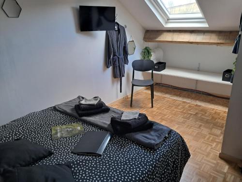 a bedroom with a bed with a laptop on it at Chambres d'hôtes chez Peggy et Eric chambre indus in Équevillon