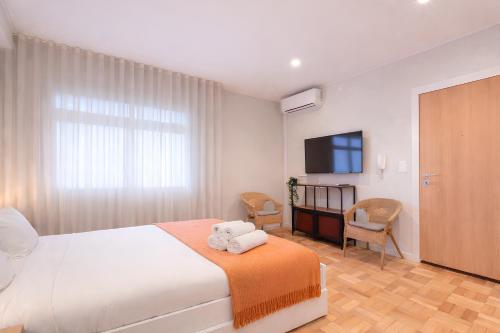 a bedroom with a bed with two towels on it at FindMe InPorto Santa Catarina in Porto