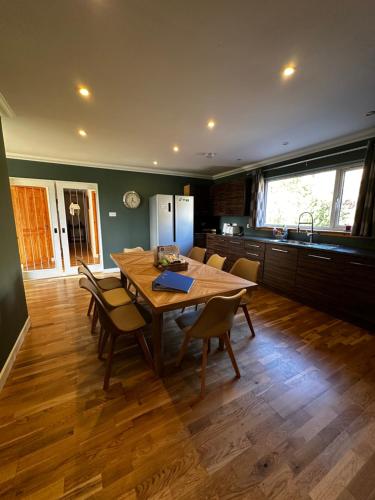 a kitchen with a wooden table and chairs in a room at Antlers Rest in Borve