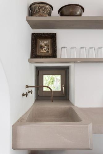 a kitchen sink in a kitchen with a window at Oxalis Villas in Perlengiánika