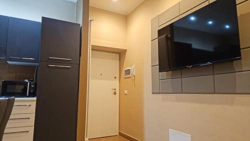 a kitchen with a large flat screen tv on the wall at Guest house Di Carlo in Sulmona