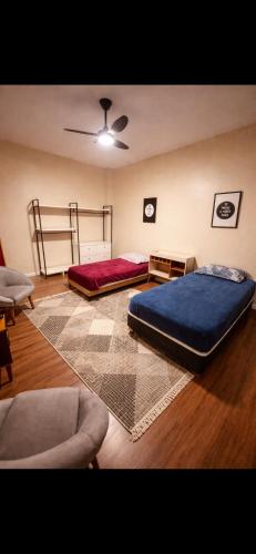 a room with two beds and a couch in it at Edifício Marília in Marília