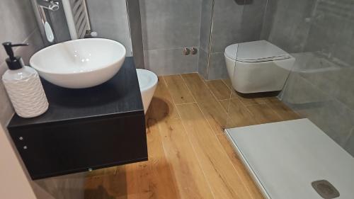 a bathroom with a sink and a toilet at Guest house Di Carlo in Sulmona