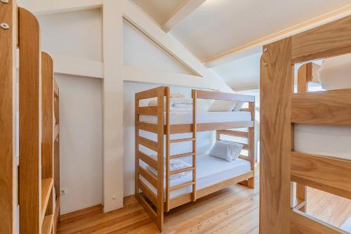 a room with two bunk beds and a ladder at HI Vila do Conde - Pousada de Juventude in Vila do Conde
