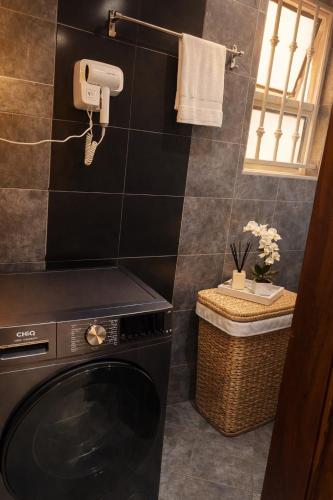 a laundry room with a washer and dryer at Cozy Apartment in Munyonyo in Munyonyo