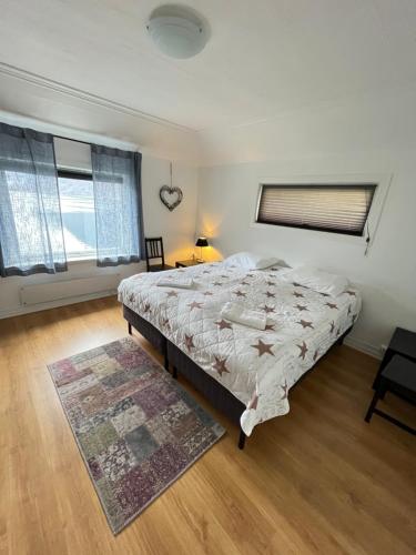 ein Schlafzimmer mit einem großen Bett und einem Teppich in der Unterkunft Gulthus in Odda