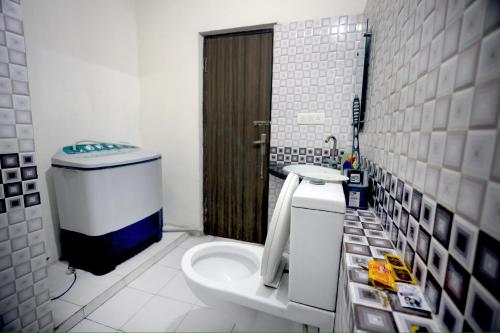 a small bathroom with a toilet and a shower at Tajiva Stay in Agra