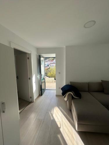 a living room with a couch and a hallway at Encanto do Rio in Bragança