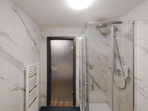 a bathroom with a shower and a glass door at ASD Hotel in Filderstadt