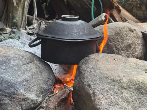 a pot sitting on top of a camp fire at Brenley B Bungalow in Talalla South