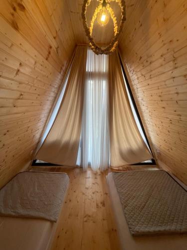 a room with a window and a chandelier at Rakushki's House 2 in Tsikhisdziri in Kobuleti