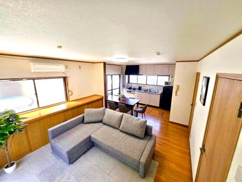 a living room with a couch and a table at Holiday Home 3 Floors 115 m Near Haneda Airport 6 Bedrooms Sleeps 9 in Tokyo