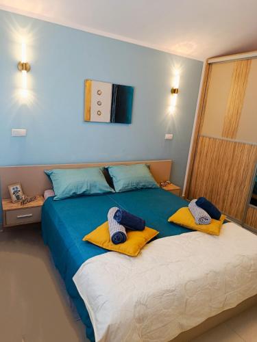 a bedroom with a large bed with towels on it at R&G Serenity Apartment in Ližnjan