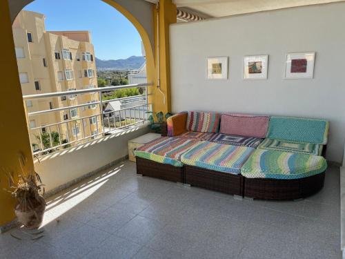 a couch sitting on a balcony with a window at Lugar junto al mar in Casas Las Basas