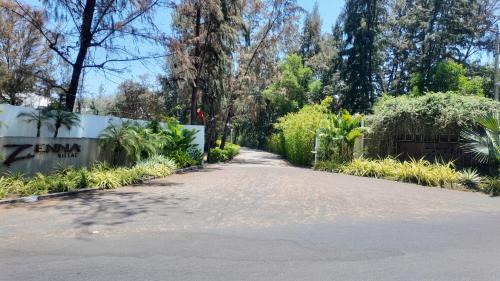 a driveway leading to the entrance to the zimmitz club at Zenna villa long Hải in Bà Rịa